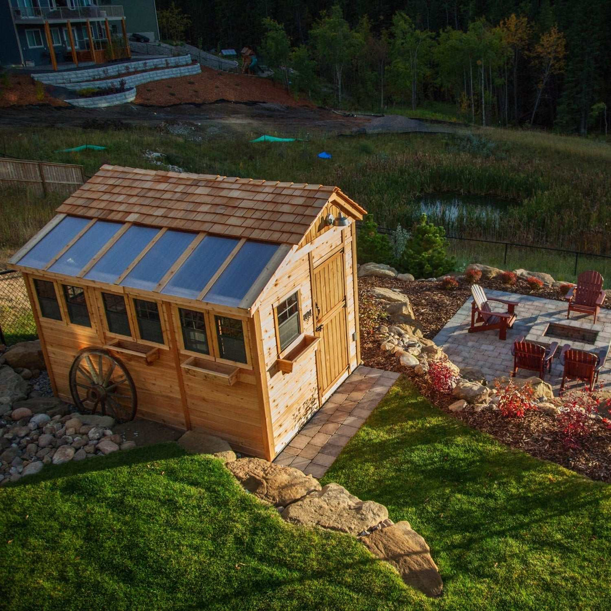 8x12 cedar shed with natural wood siding, shingle roof, glass-panel roof, windows, and decorative wagon wheel
