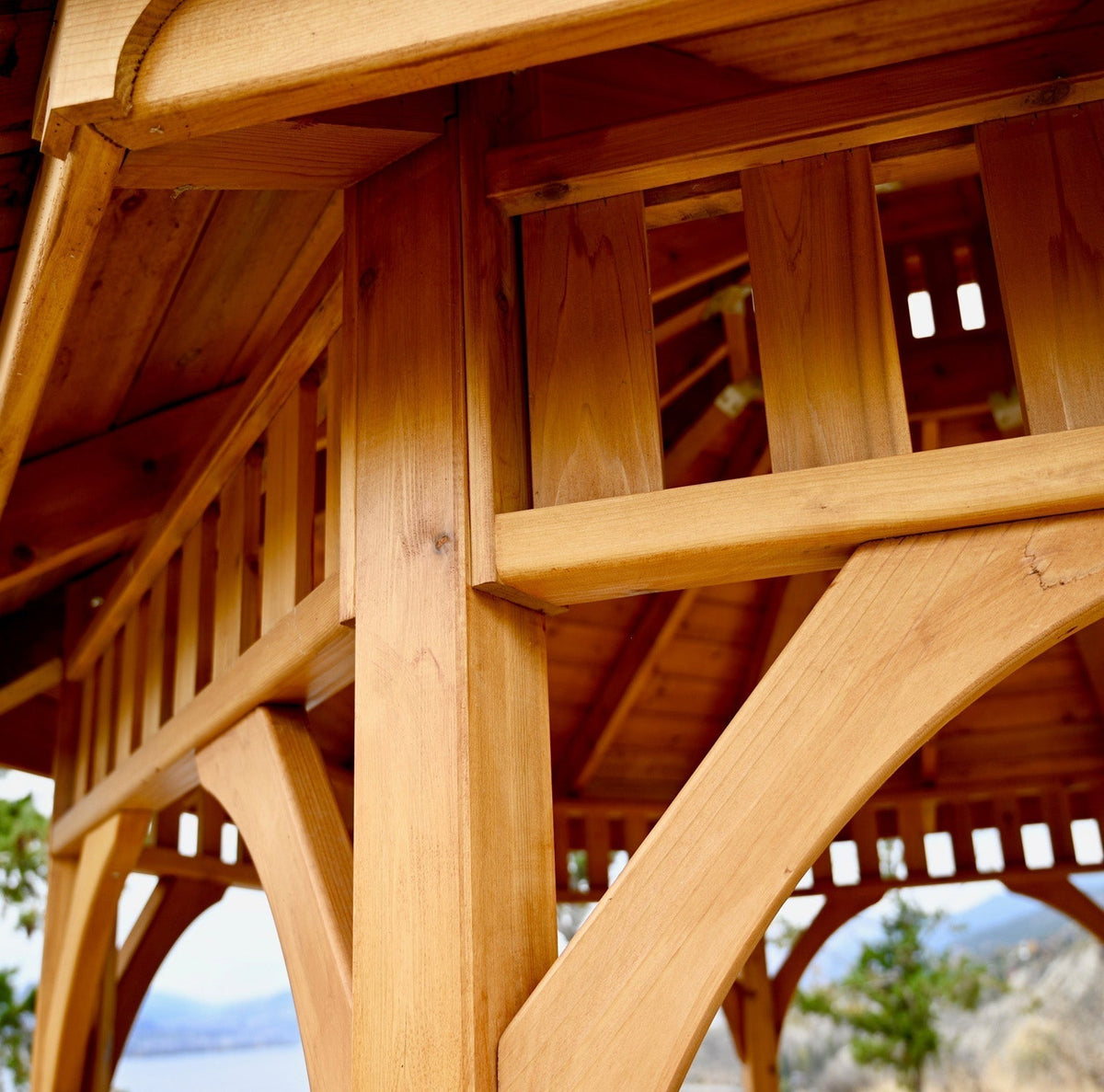 Outdoor Living Today cedar gazebo with warm wood posts, railings, arched braces, and detailed joinery