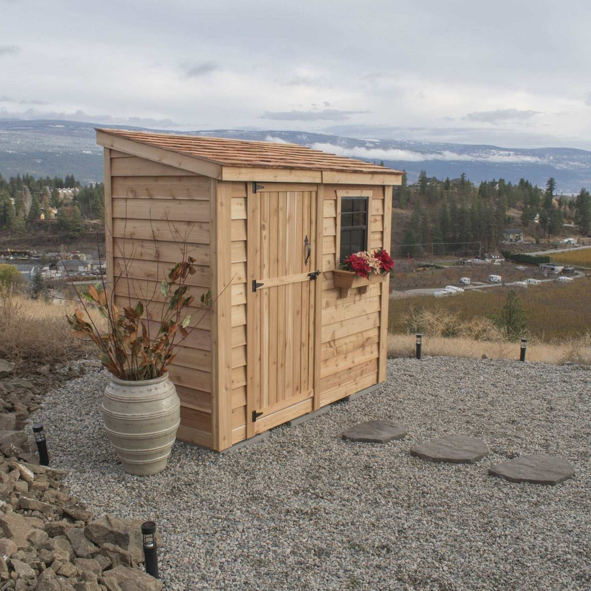 Cedar storage shed with single door, window flower box, slatted roof, and Panelized Wall Design