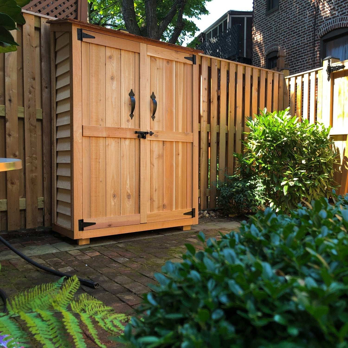 Western Red Cedar Garden Chalet compact wooden shed with double doors and black metal handles, natural cedar finish