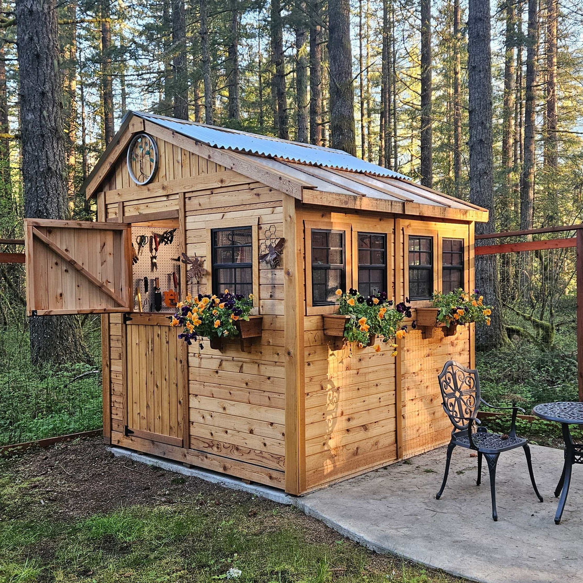 Western Red Cedar garden shed with natural wood siding, corrugated metal roof, Dutch door, windows, and flower boxes